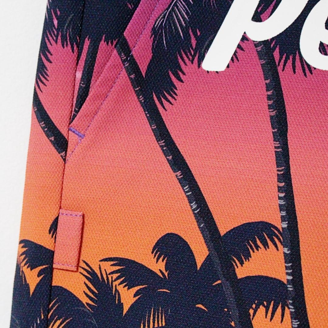 新品 パーリーゲイツ ヤシの木柄 ストレッチパンツ M（W76-80cm夕焼け色